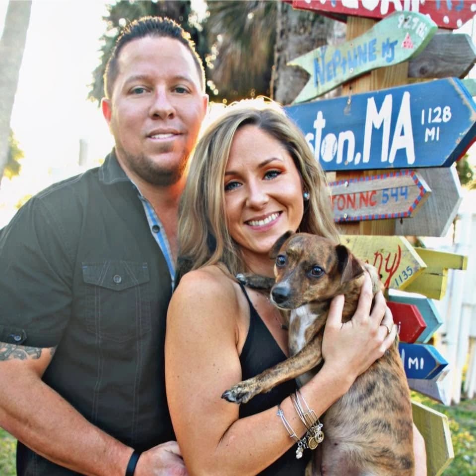 Jesse Griffith, pictured on the left, outdoors with a woman holding a dog